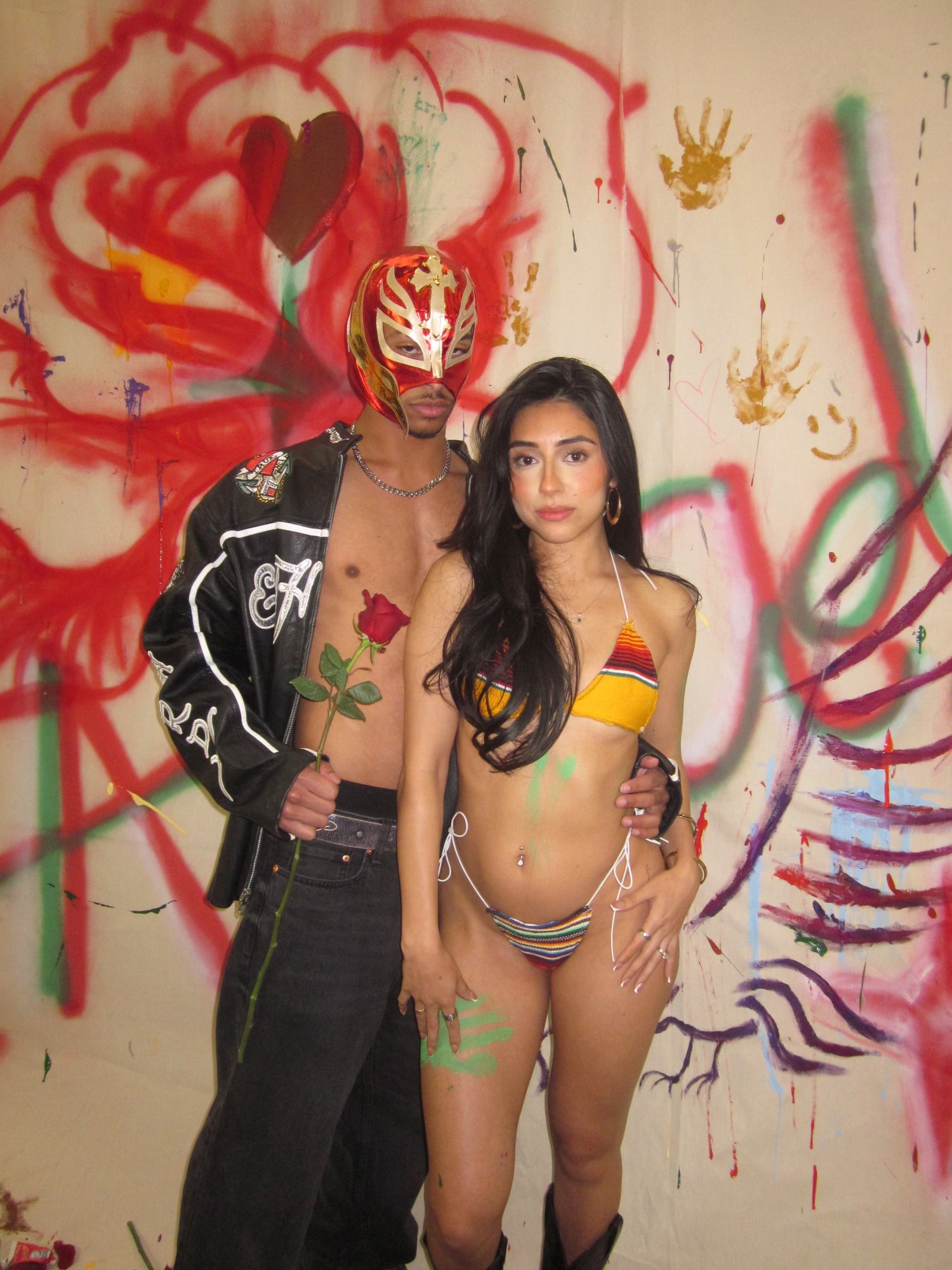 model wearing el sol bikini with male in wrestling mask with rose in hand